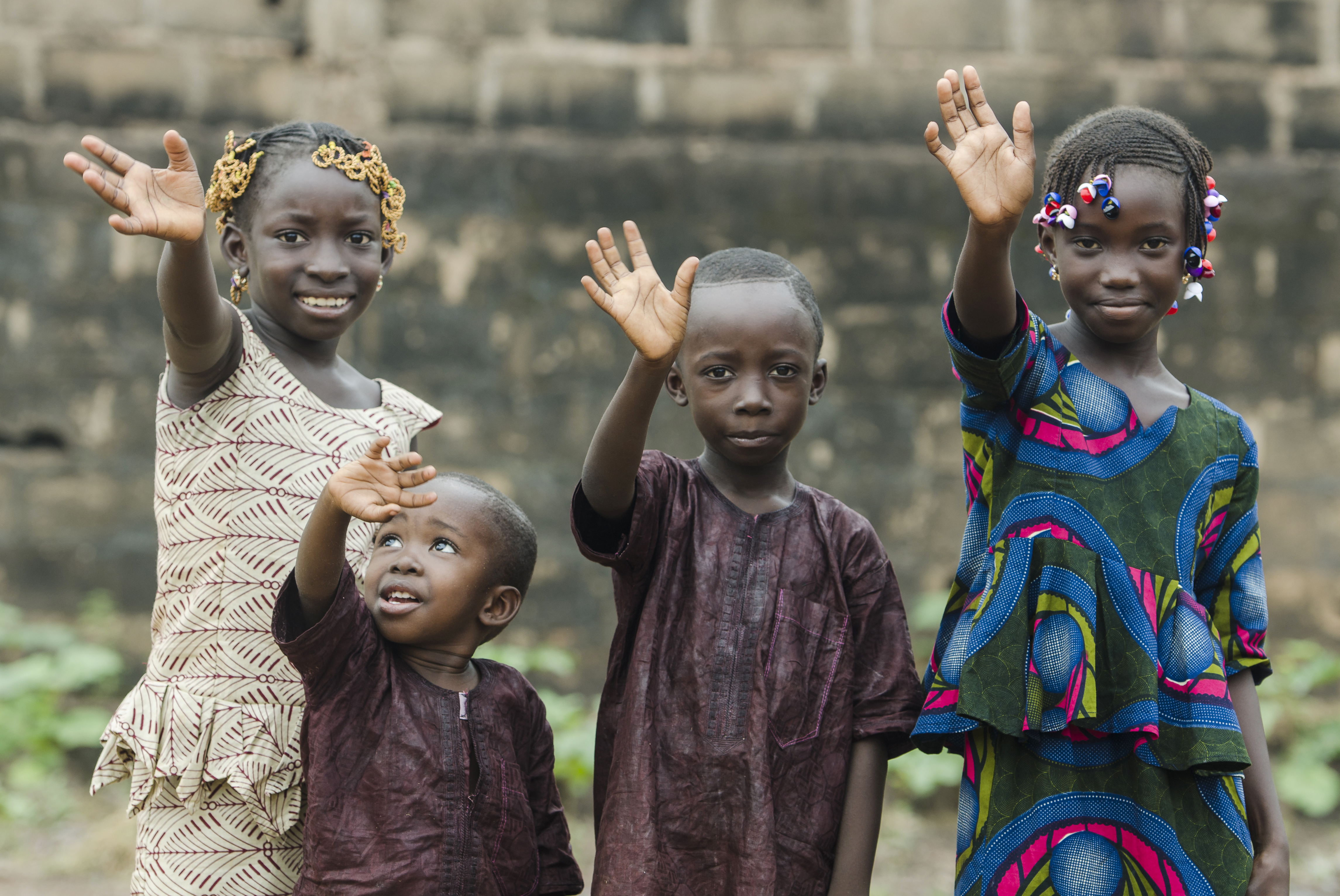 four African children waving